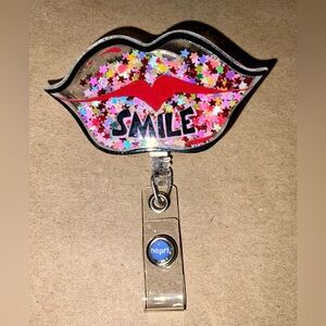 2 new in packages badge holders/reels - lips/smile design and smile/wink face